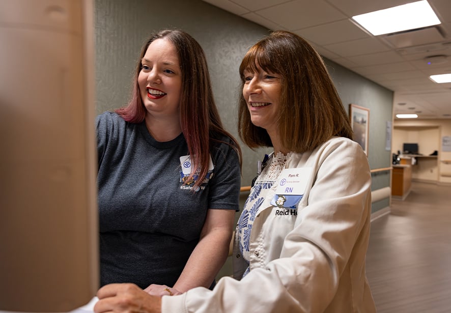 Two Reid Health nurses working together