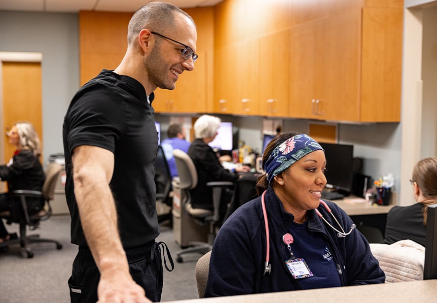Reid Health's Neurologist, Jordan Raynor, MD working with Lakeyah Carpenter, RN
