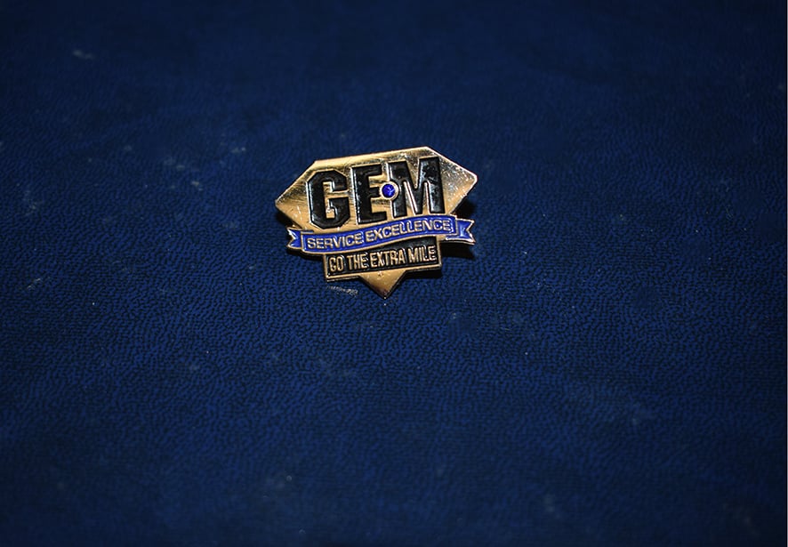 An image of the pin an employee would receive in recognition of their GEM