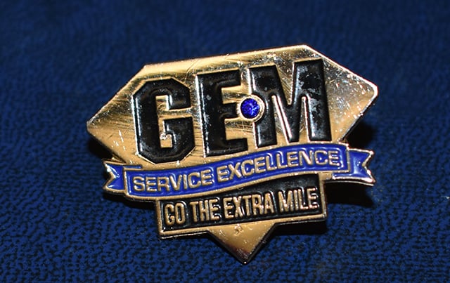 An image of the pin an employee would receive in recognition of their GEM