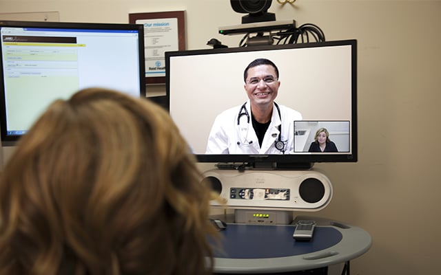 Reid Health Cardiologist, Rubinder Dab, MD having a telehealth appointment with a patient