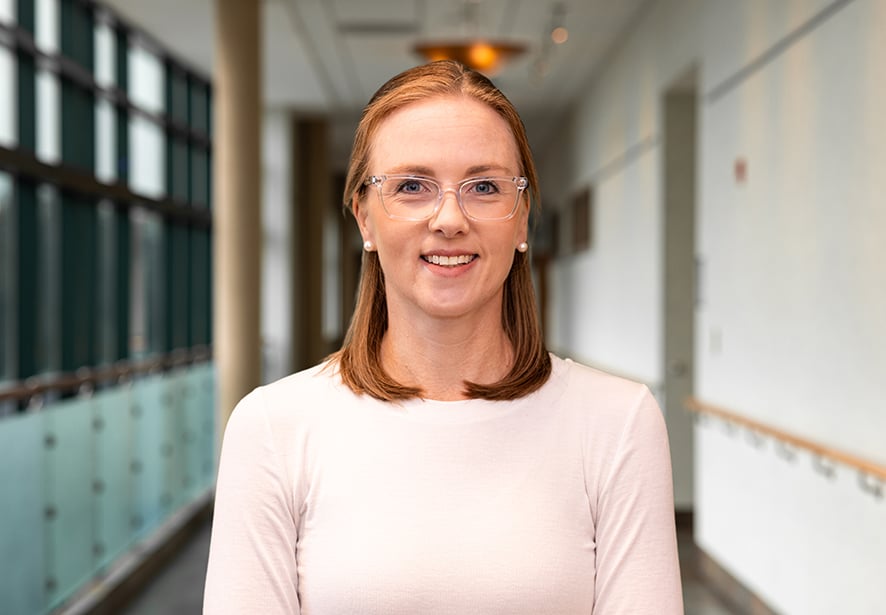 Lindsey Porta, MD, Primary Care physician at Reid Health, smiling while standing in a hospital corridor.