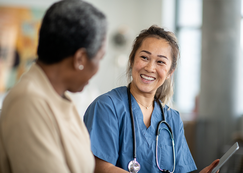 Provider smiles and talks with patient