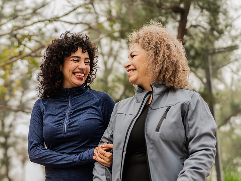 two women walking together outside