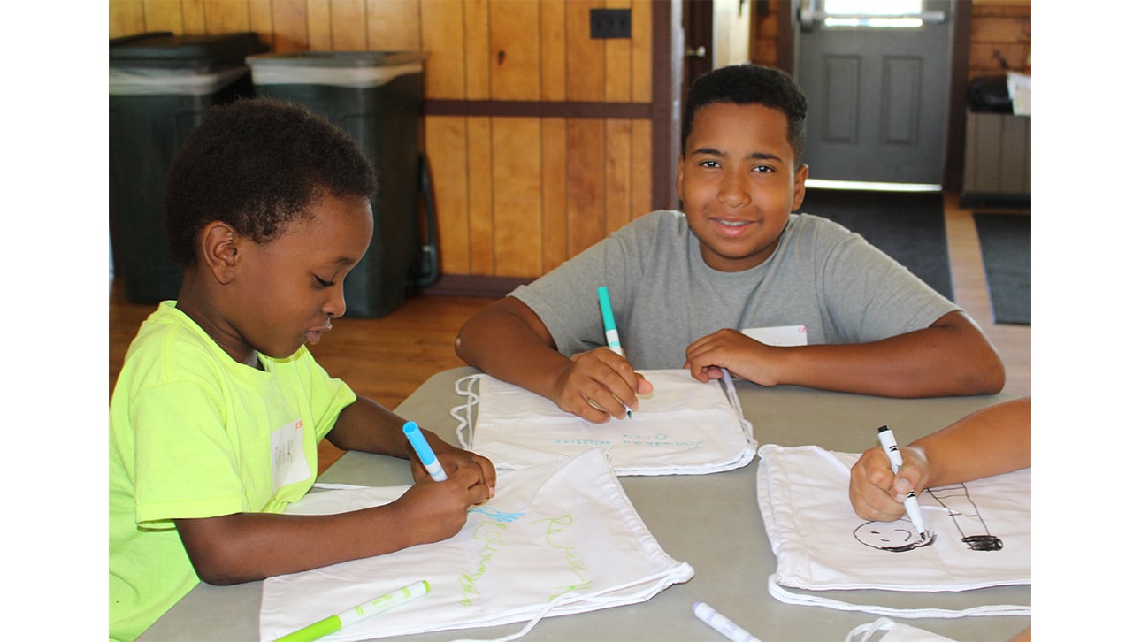 two boys drawing at CompassionNet's SibsROCK! day