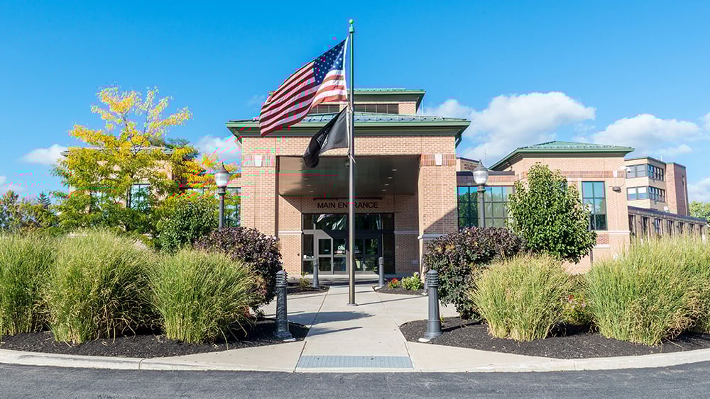 United Memorial Medical Center exterior photo brick hospital blue skies american flag