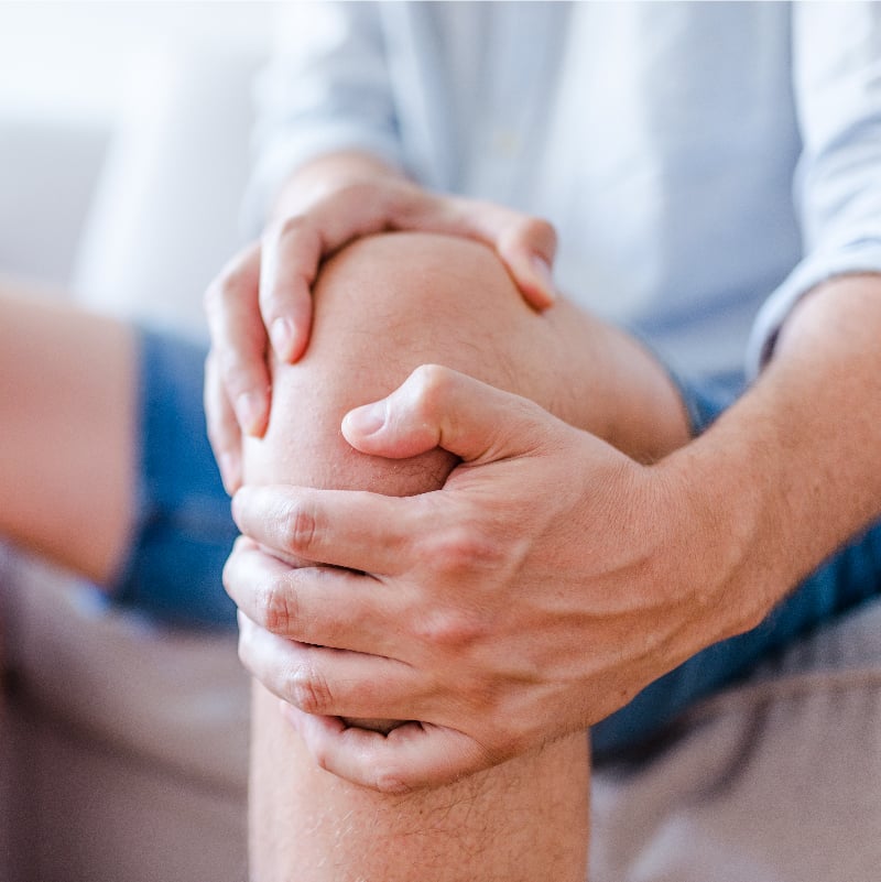 Man holding knee.