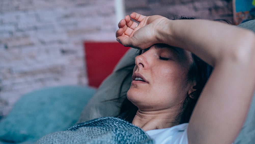 Woman lying on couch with COVID