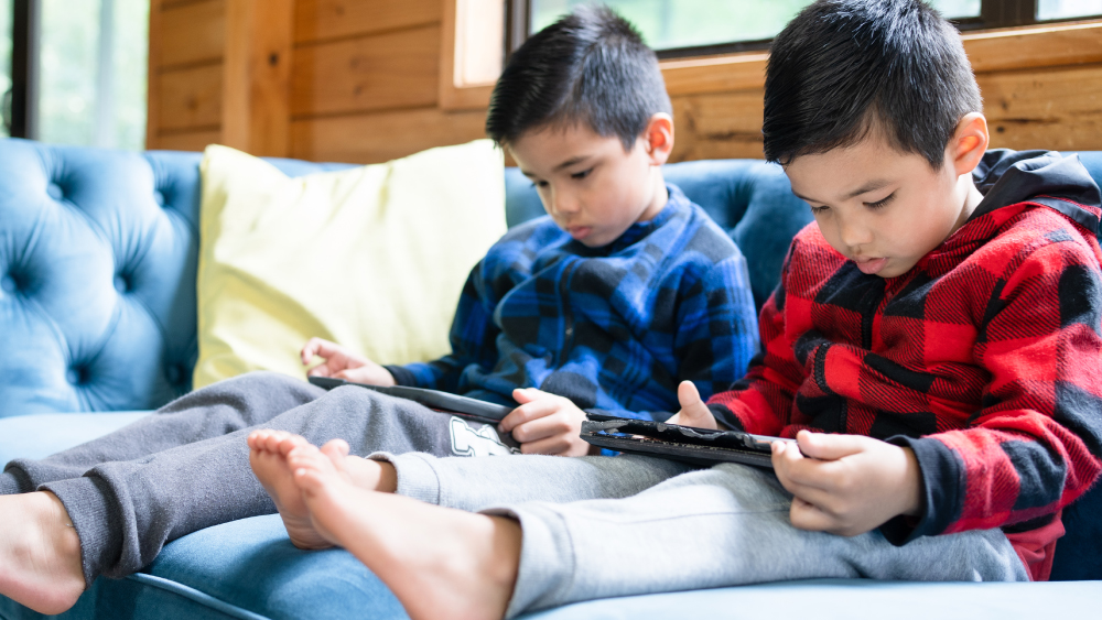 Two young boys on tablets