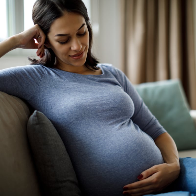 pregnant woman holding her stomach lovingly 