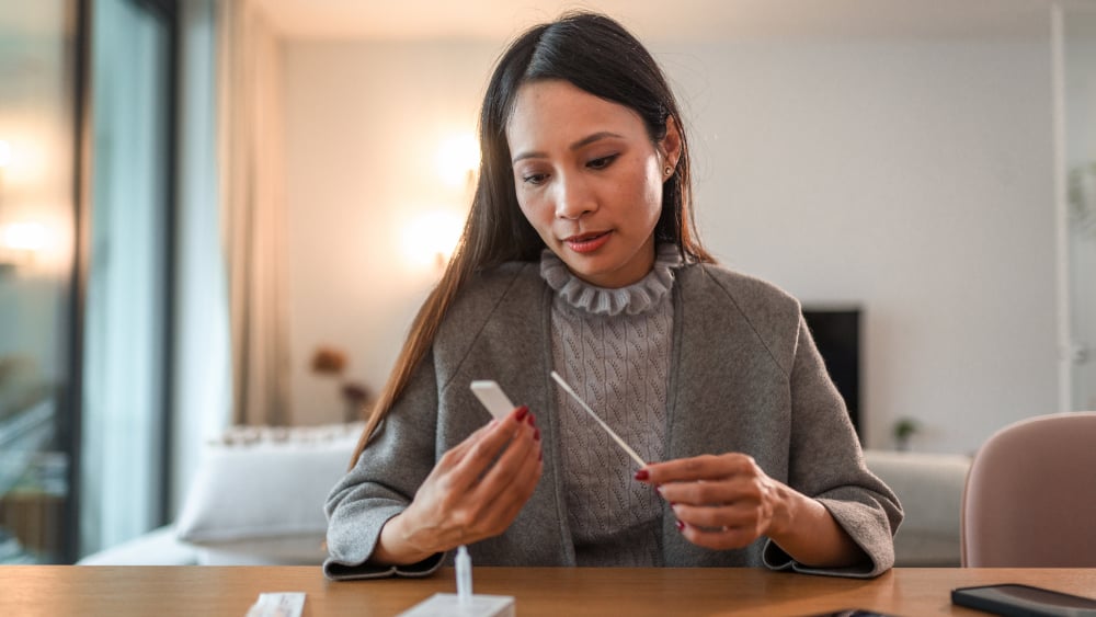 Woman looking at home COVID test