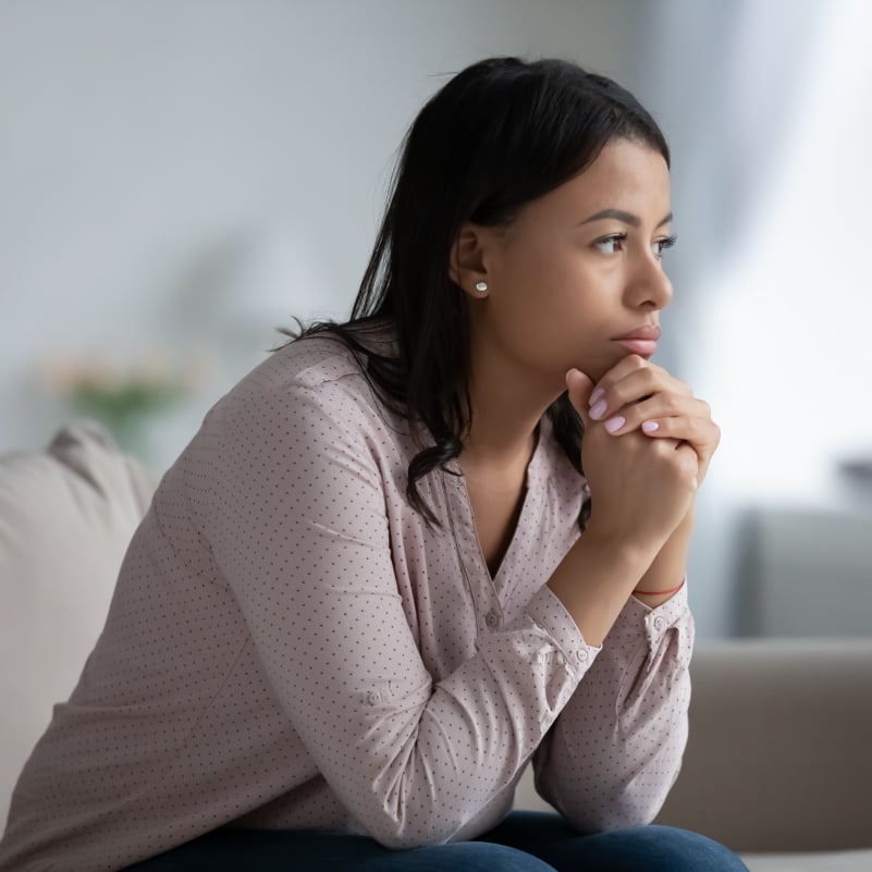 female holding her hand and looking afar and contemplating