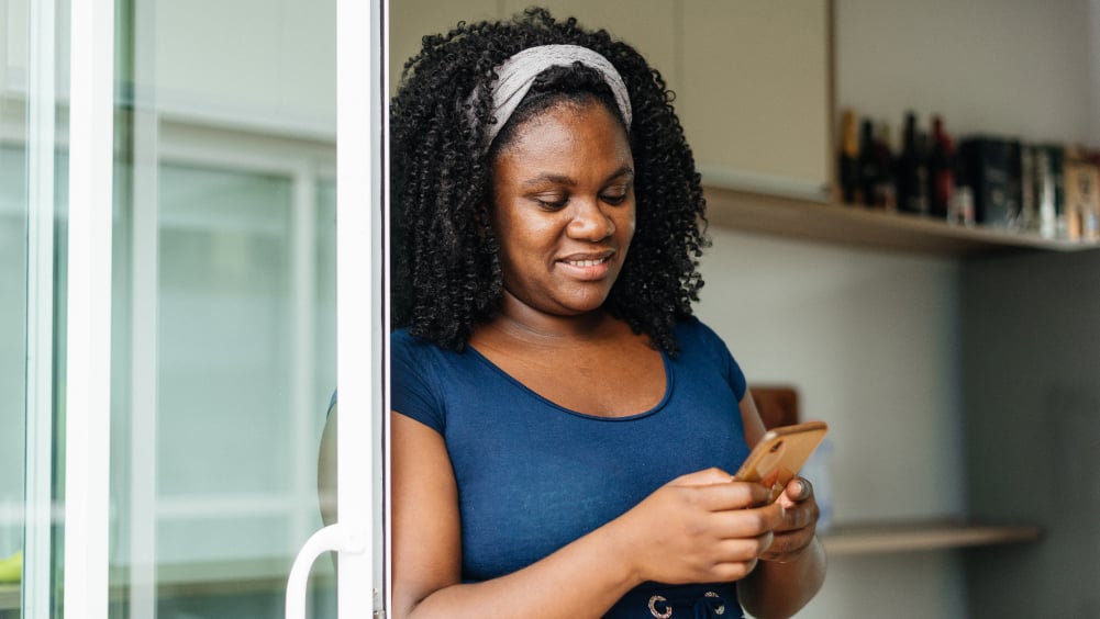 Woman scheduling mammogram on phone