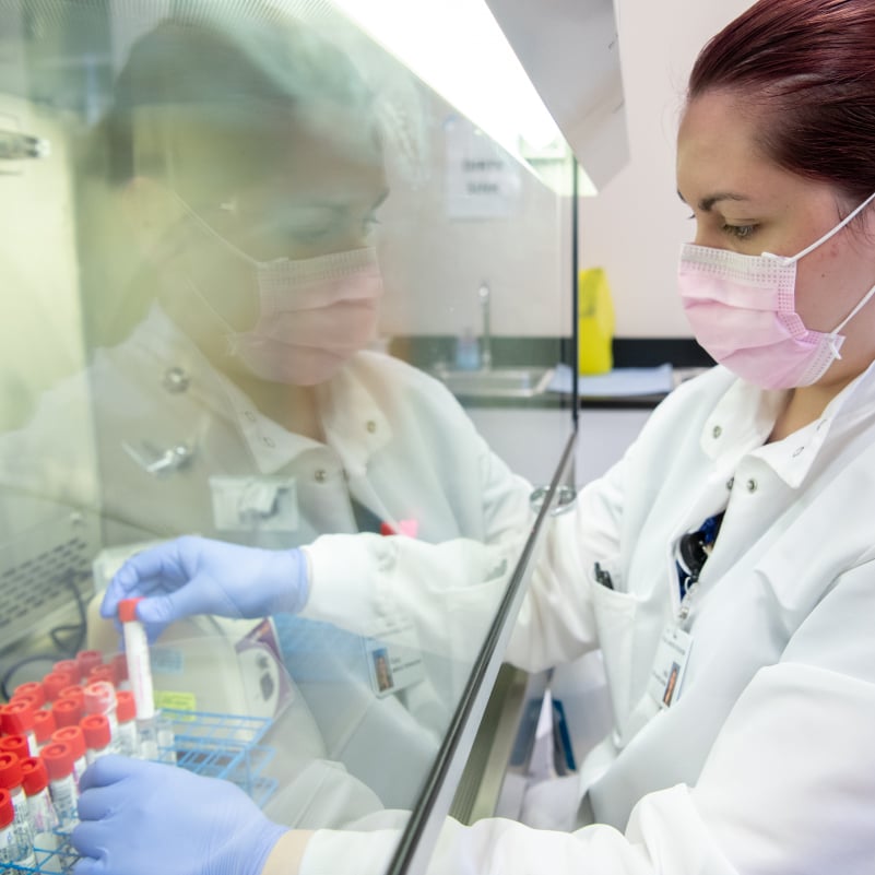 scientist in a testing lab holding a test tube