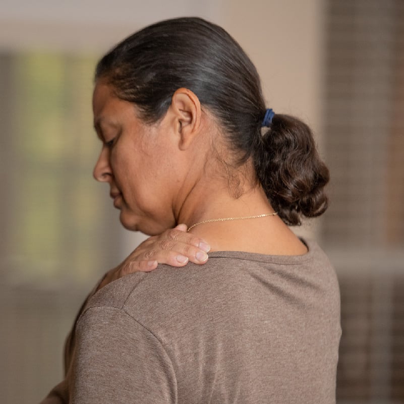 woman holding her should