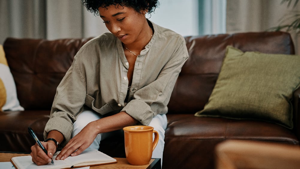 female writing in her journal