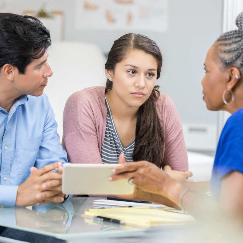 A parent, young woman, and a provider discuss the young woman's health