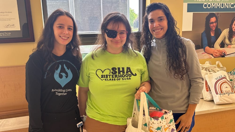 Reagan Cutler holding comfort bags for pediatric patients