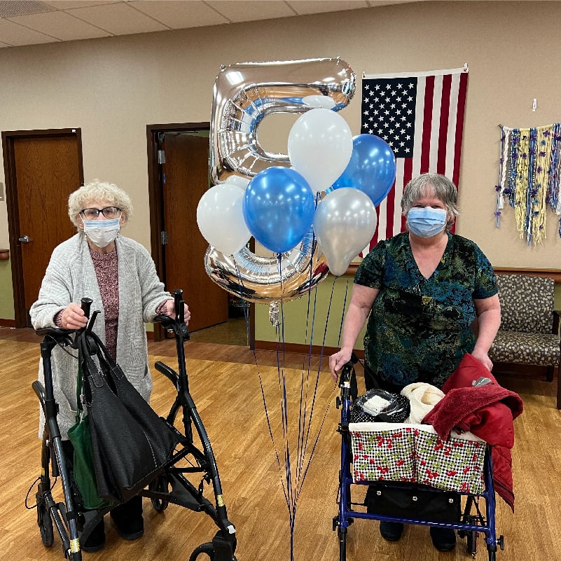 Two women celebrate the 5 year anniversary of ElderONE Silver Hill