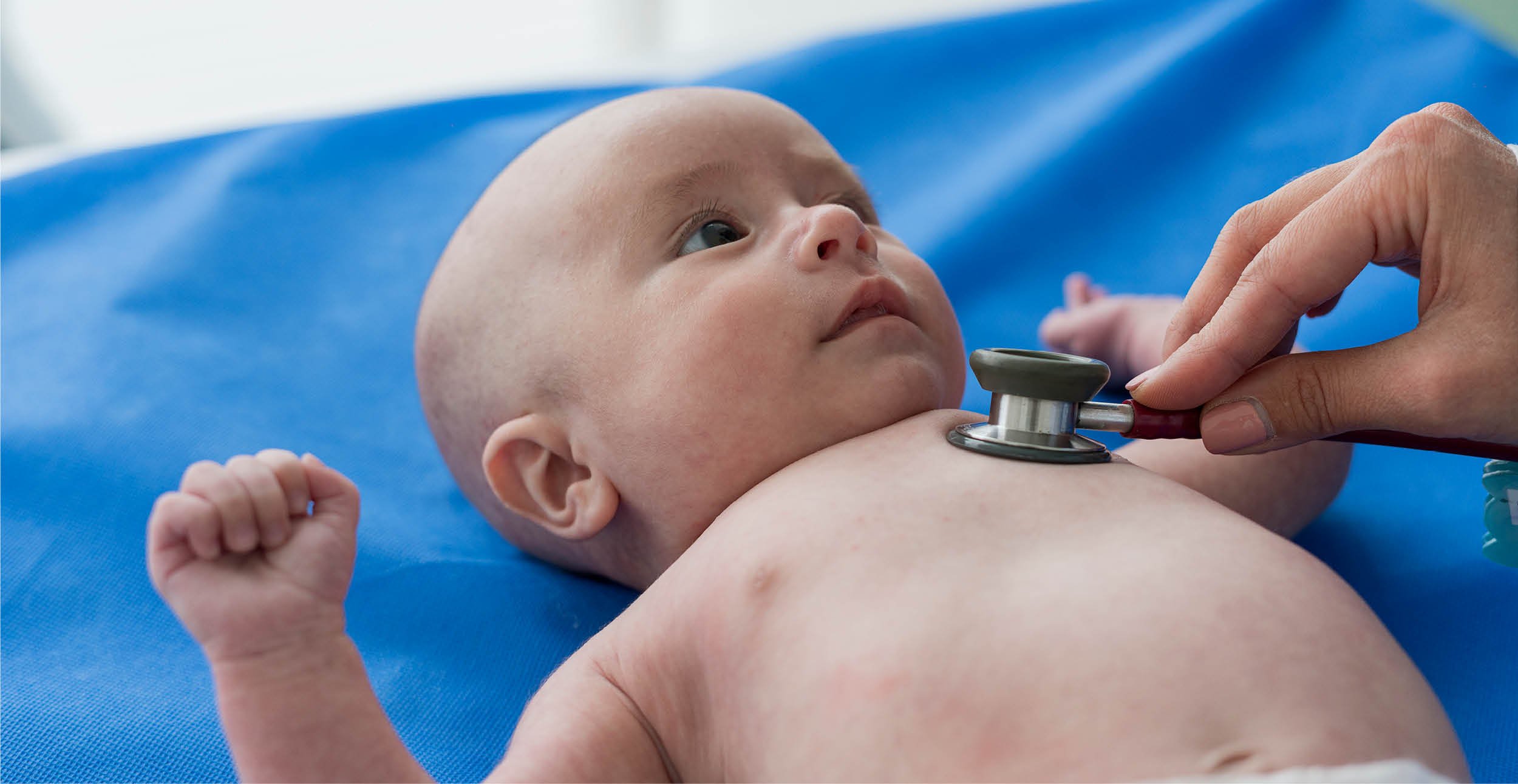 A baby with a stethoscope on its chest