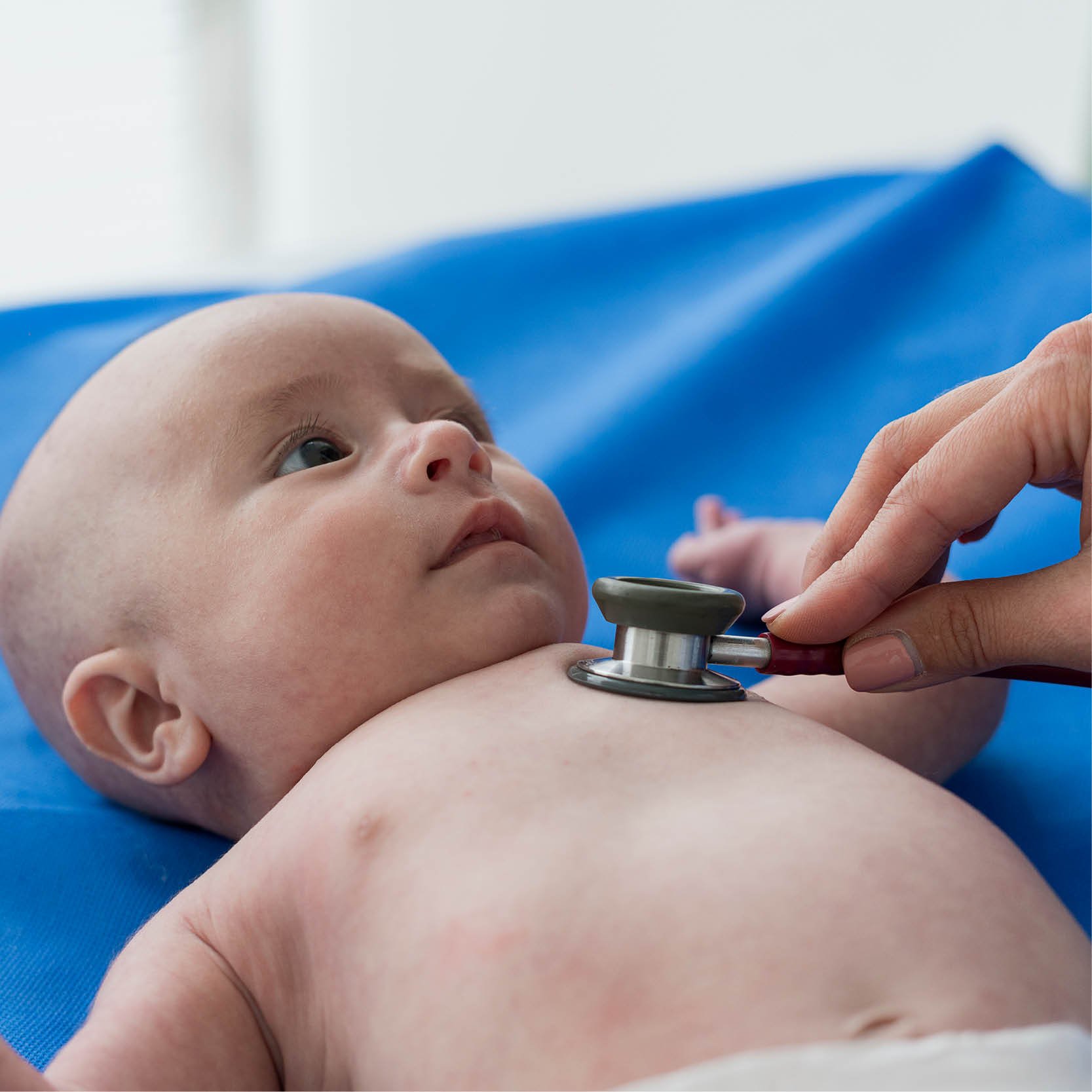 A baby with a stethoscope on its chest