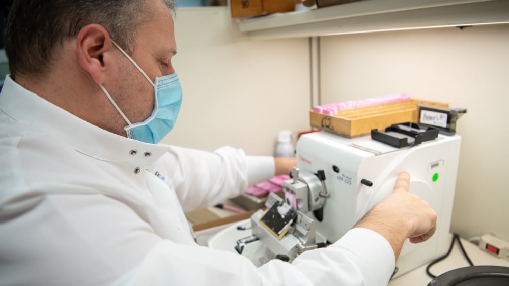 Histotechnologist with a microtome