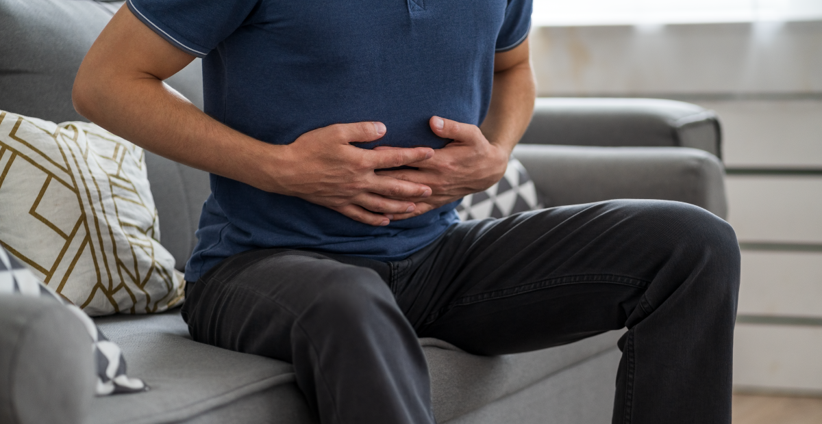 Man holding stomach in discomfort