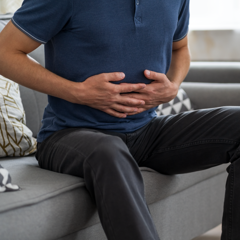 Man holding stomach in discomfort