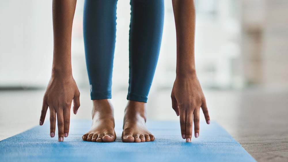 A person stretches on a yoga mat