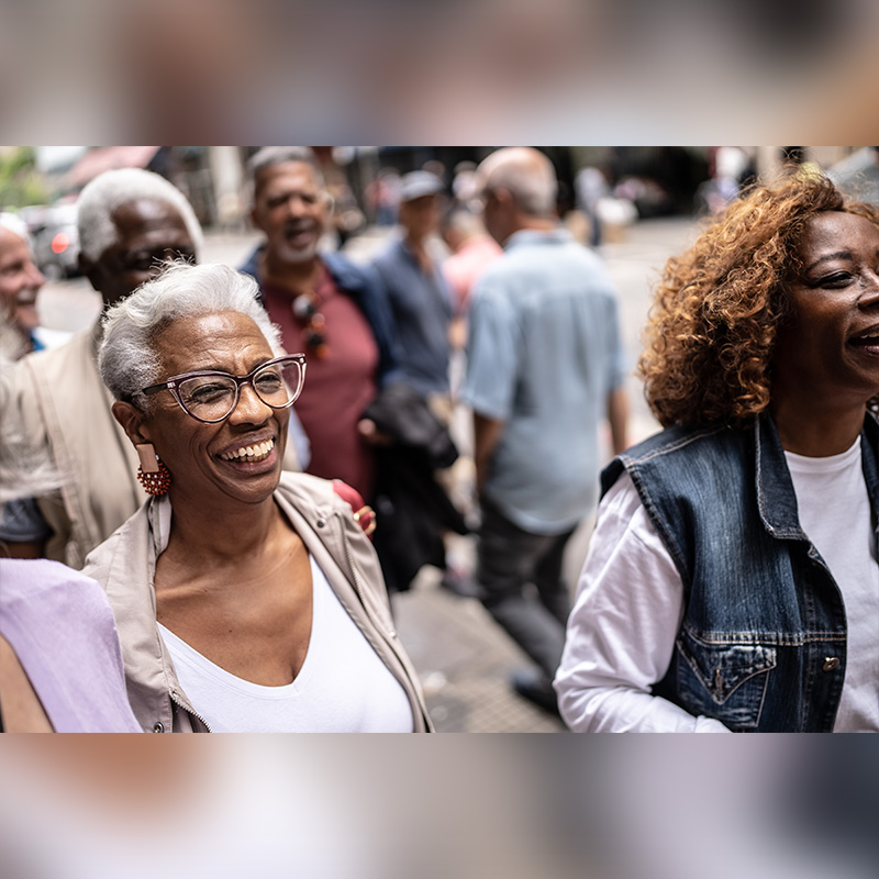 Seniors smiling and walking in a downtown area