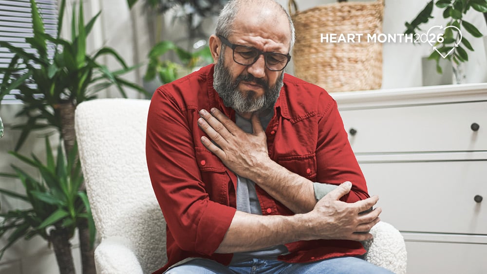 Man holding chest in pain
