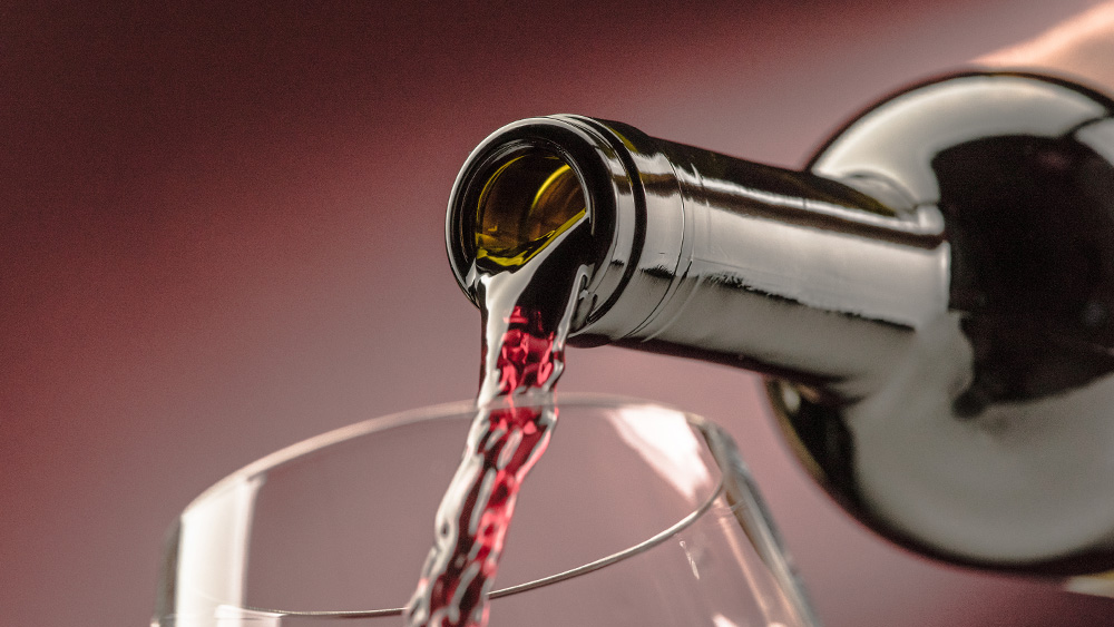 Red wine poured from bottle to glass