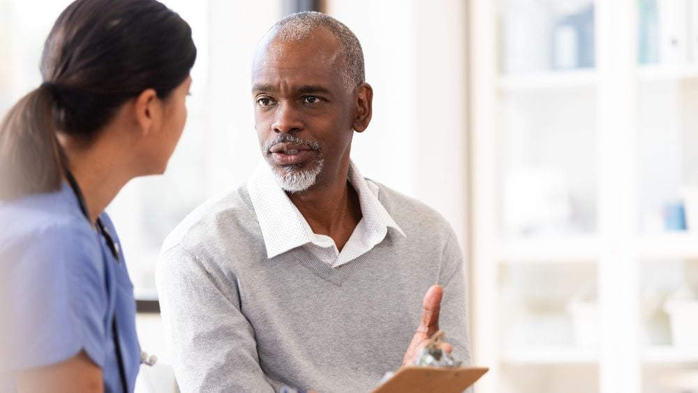 Male patient talking with doctor
