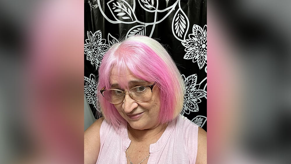 Amy French with short white and pink hair