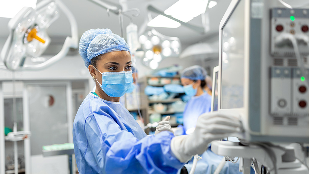 Anesthesiologist adjusts levels in operating room