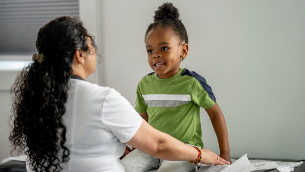 Young Black child meets with female healthcare provider