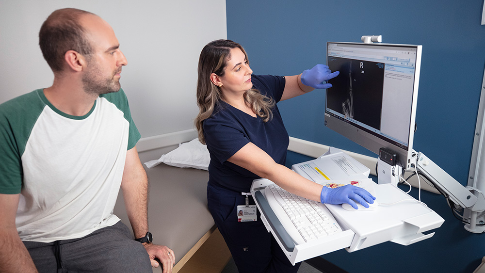 Man and physician assistant look at xray