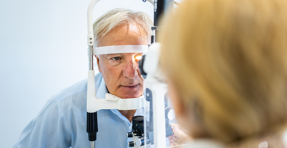 Senior man undergoing intraocular pressure exam at optometrist office
