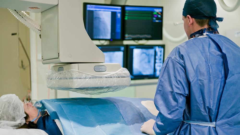 Cath lab in modern hospital with doctor and patient