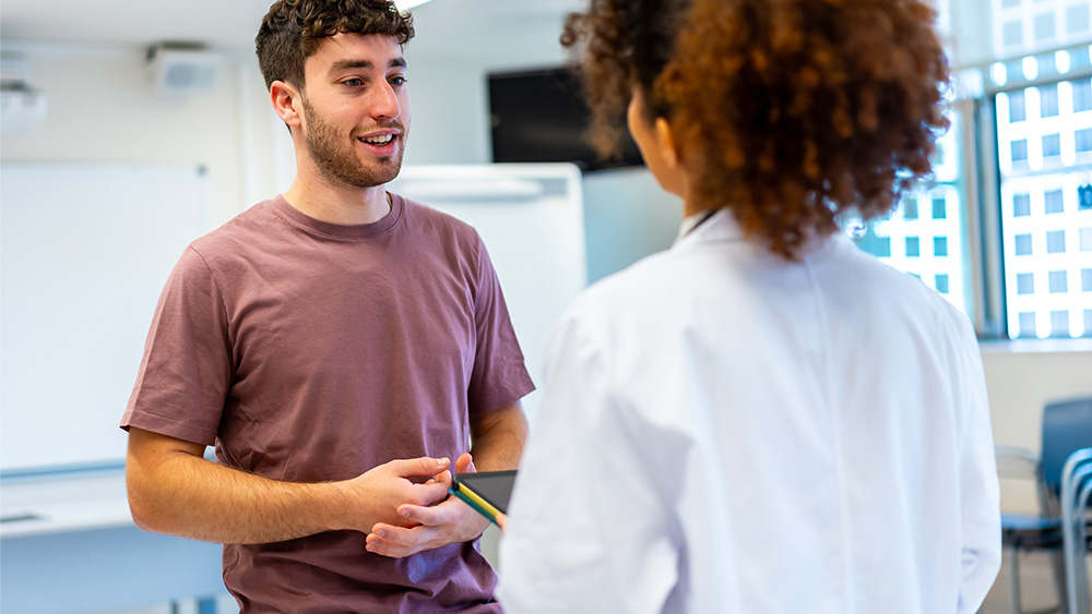 college student talking with provider about STDs