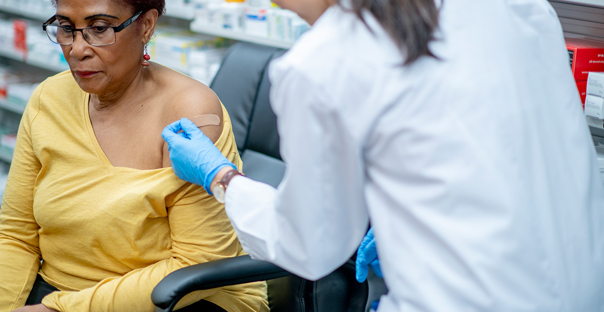 An older woman gets vaccinated at the pharmacy