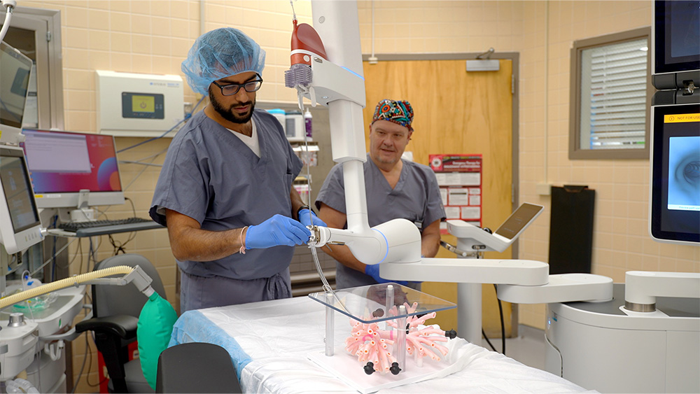 St. Lawrence Region Pulmonologist Rishi Kumar, MD, provides a demonstration of the robotic bronchoscopy now being used at Canton-Potsdam Hospital. He is being assisted by David Weitz, RN.