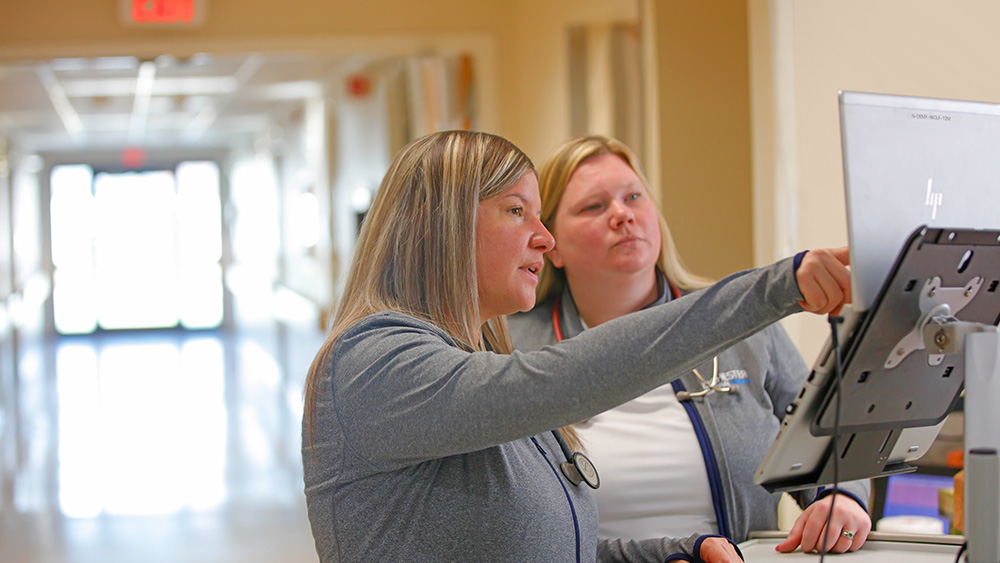 Nurses working at computer station