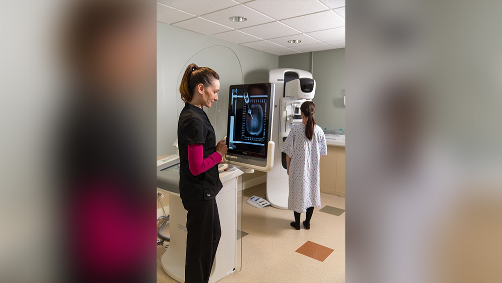 Mammography tech helps patient during mammogram