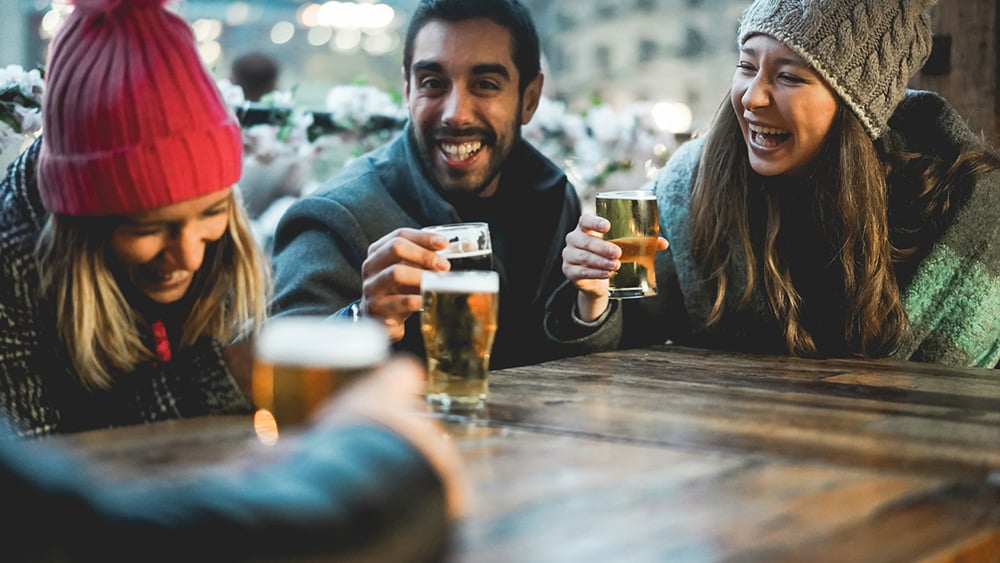 Young friends having fun together drinking beer at bar restaurant