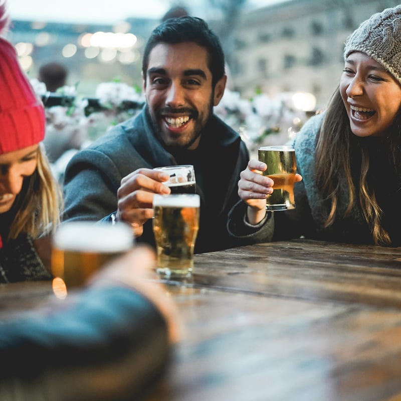 Young friends having fun together drinking beer at bar restaurant