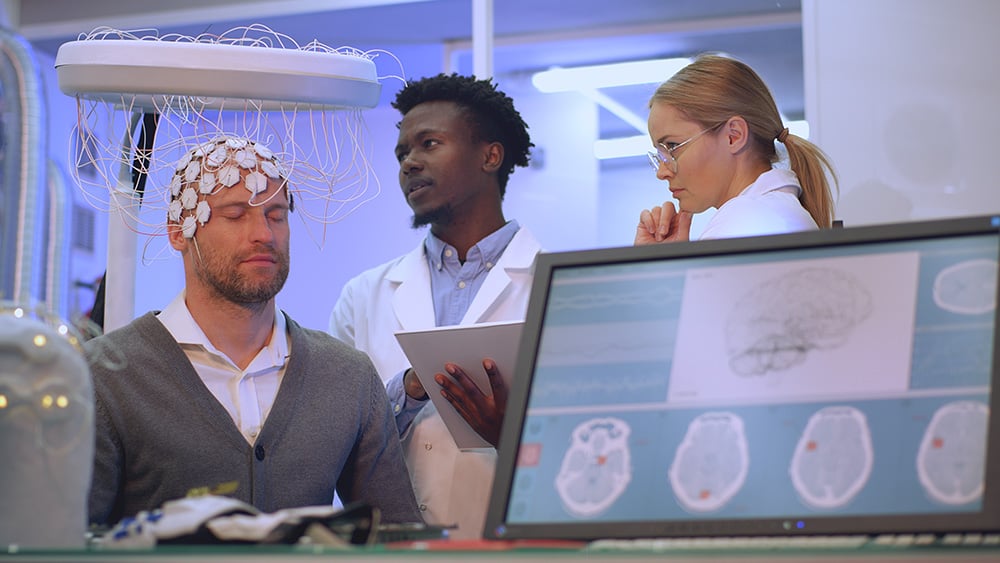 Scientists examines headset in modern Neurological Research Laboratory