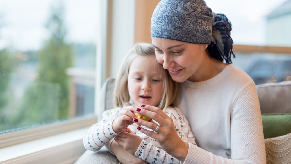 Young girl with mother who is a cancer patient