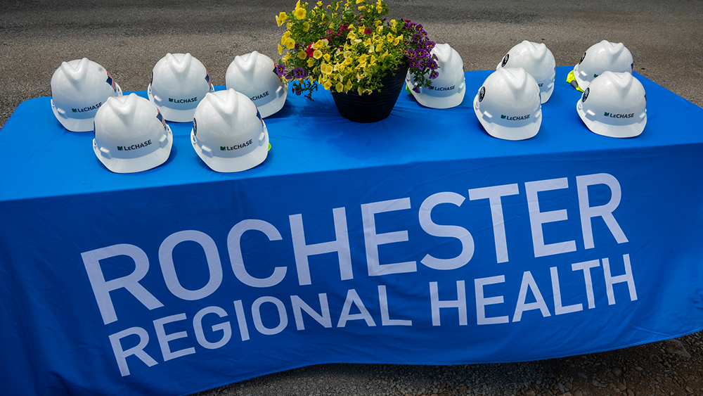White hard hats on a blue tablecloth