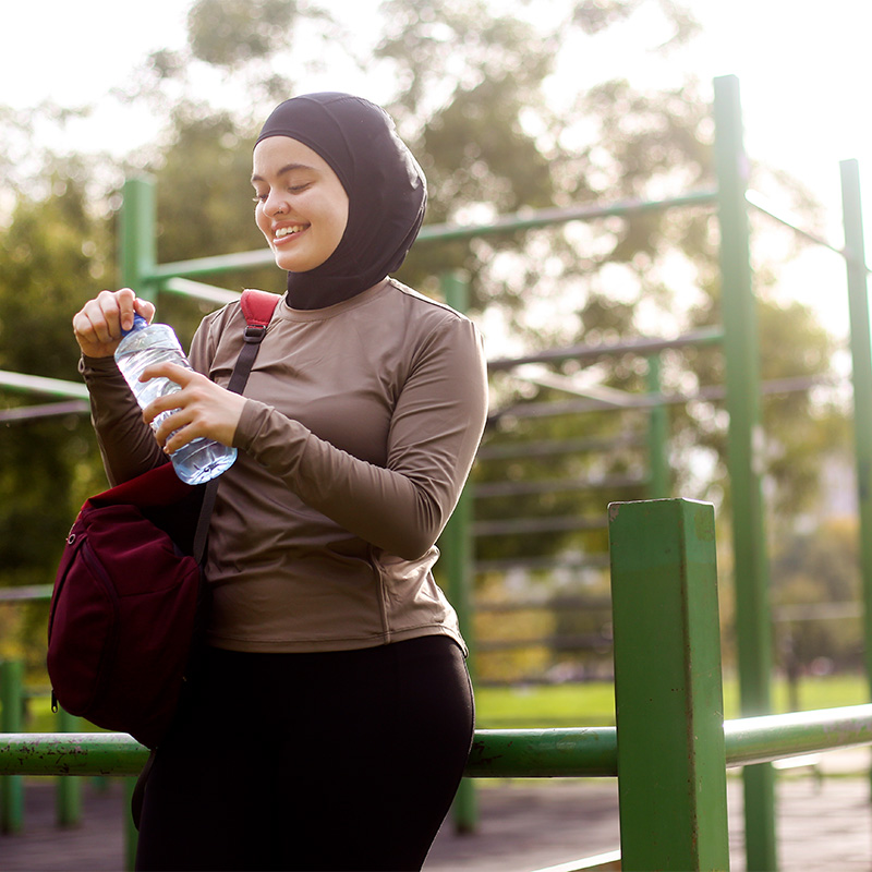 Middle-eastern female exercising in a park. About 25 years old, Arab woman